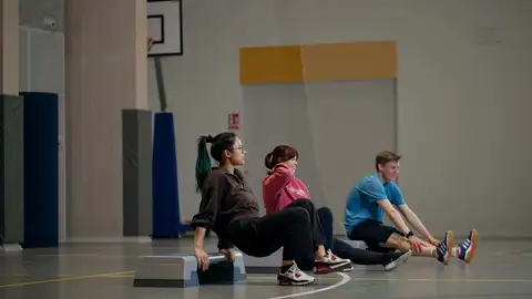 Three people exercising.